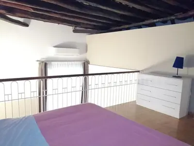 a bedroom with a purple bed and a white dresser at Da Ale alla Cattedrale in Palermo