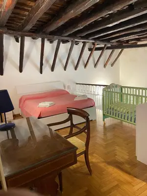a bedroom with a bed and a table in a room at Da Ale alla Cattedrale in Palermo