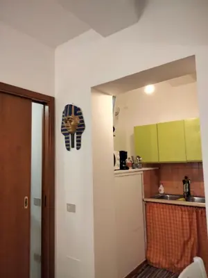 a kitchen with a sign of a lion on the wall at Casa di fronte la Cattedrale in Palermo