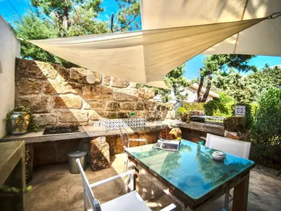 a patio with a table and chairs and a stone wall at Villa Re di Denari by Interhome in Terrasini
