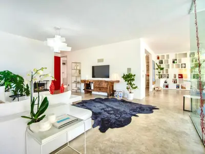 a living room with white walls and a blue rug at Villa Re di Denari by Interhome in Terrasini