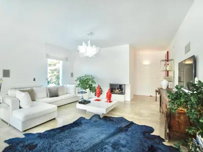 a living room with white furniture and a blue rug at Villa Re di Denari by Interhome in Terrasini