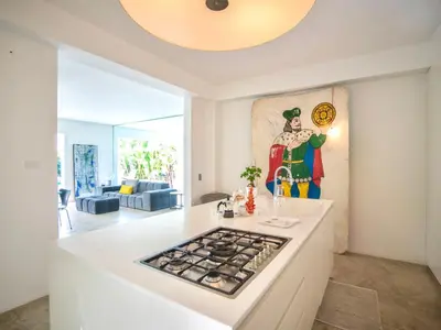a kitchen with a stove and a painting on the wall at Villa Re di Denari by Interhome in Terrasini
