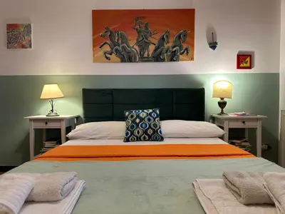 a bedroom with a large bed with two night stands at Villa dell’Orsa in Cinisi
