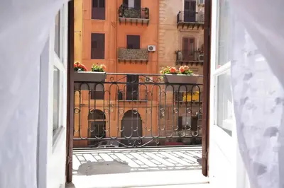 an open balcony with flowers on a building at La Casetta 90139 in Palermo