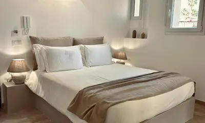 a bedroom with a bed and a mirror and a desk at Palermo Inn Boutique Hotel in Palermo