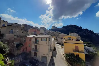 a group of buildings in a town on a hill at La Domus di Segesta in Calatafimi