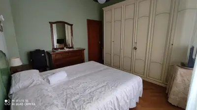 a bedroom with a bed and a dresser and a mirror at POLICLINICO HOME in Palermo
