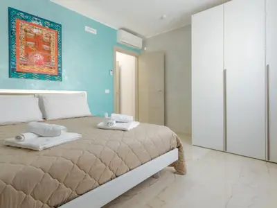 a bedroom with a bed with two towels on it at Azzurra Apartments in Balestrate