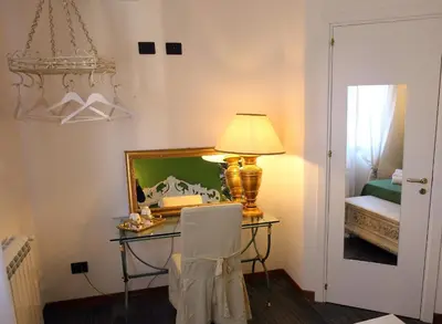 a room with a desk with a lamp and a mirror at Accardi House Searooms in Palermo