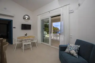 a living room with a couch and a table at Kafara Resort- Villas and Pool by Lisca Bianca Rental in Santa Flavia