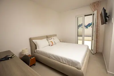 a white bedroom with a bed and a window at Kafara Resort- Villas and Pool by Lisca Bianca Rental in Santa Flavia