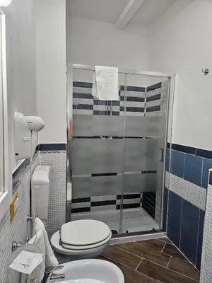 a bathroom with a shower with a toilet and a sink at la palma in Castellammare del Golfo