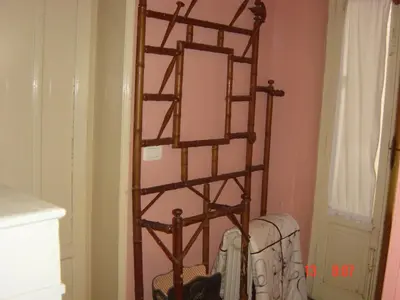a wooden towel rack in a room with a chair at Rosella Bianchi in Palermo