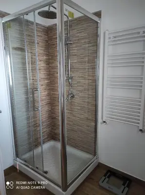 a shower with a glass door in a bathroom at La casa di Giulio - holiday home in Isola delle Femmine