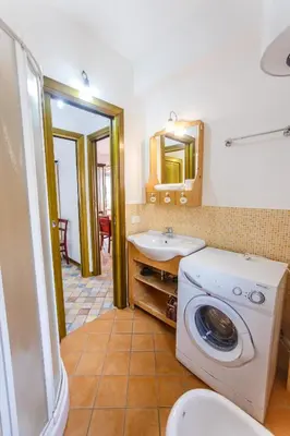 a bathroom with a washing machine and a sink at SanvitoTour - Oasi nel Mare in San Vito lo Capo