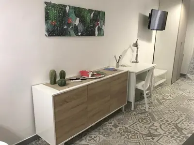 a room with a desk with a cactus on the wall at Sweet home Ballaro' in Palermo