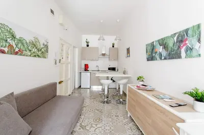 a living room with a couch and a kitchen at Sweet home Ballaro' in Palermo