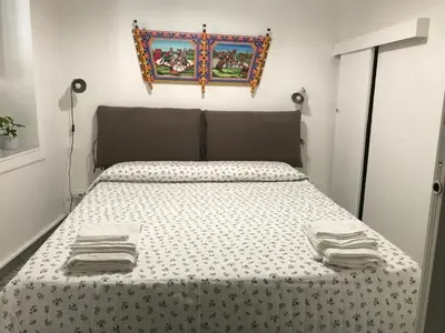 a bedroom with a bed with a black and white comforter at Sweet home Ballaro' in Palermo