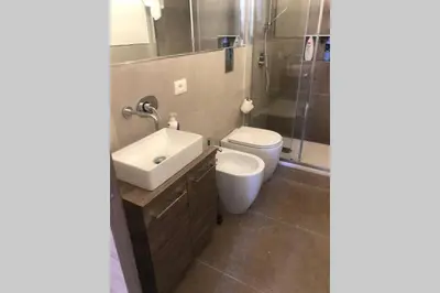 a bathroom with a toilet and a sink and a shower at casa vacanza roberto in Palermo