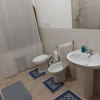 a bathroom with a sink and a toilet and a shower at Villa Torre Magaggiari in Cinisi