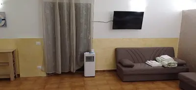 a living room with a couch and a television at Villa Torre Magaggiari in Cinisi