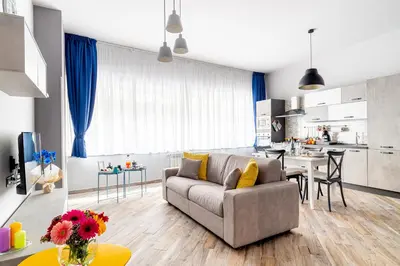 a living room with a couch and a kitchen at Dream Home in Palermo