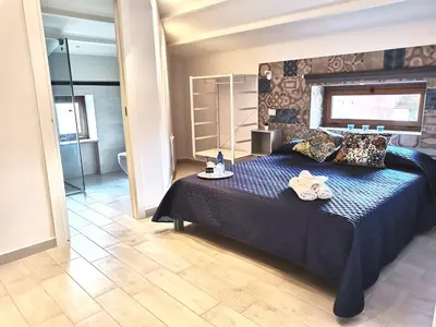a bedroom with a blue bed with towels on it at Le Métro in Carini