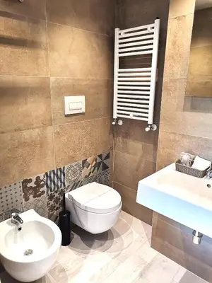 a bathroom with a toilet and a sink at Le Métro in Carini