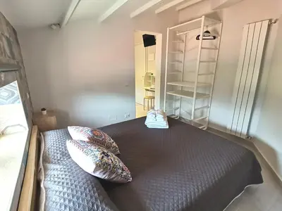 a bedroom with a bed with two pillows and a mirror at Le Métro in Carini
