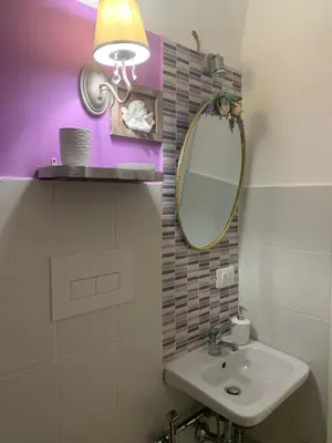 a bathroom with a sink and a mirror at Le Lanterne di Terrasini in Terrasini