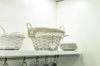 two baskets sitting on a shelf with plates at Corleone GUESTHOUSE in Corleone
