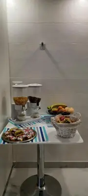 a table with two plates of food on it at Corleone GUESTHOUSE in Corleone