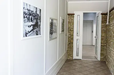 a hallway with pictures on the walls of a house at Corleone GUESTHOUSE in Corleone
