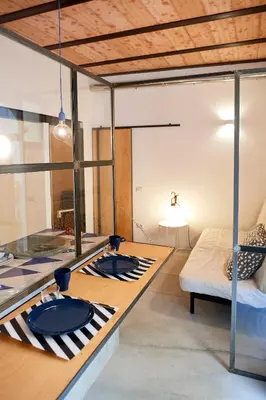a room with a table and a bed in it at Mediterranea - Piccola Dimora per Viaggiatori in Castellammare del Golfo