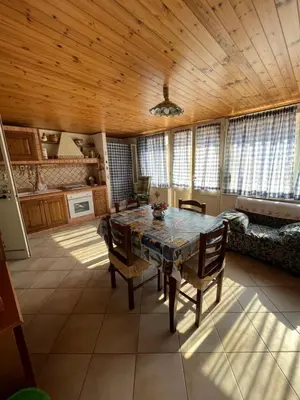a dining room with a table and some windows at Casa Vacanze Salvatore in Balestrate