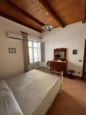 a bedroom with a bed and a dresser and a mirror at Casa Vacanze Salvatore in Balestrate