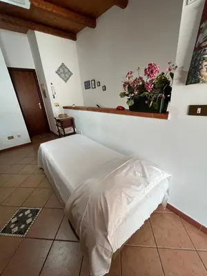 a bedroom with a bed with a plant on the wall at Casa Vacanze Salvatore in Balestrate