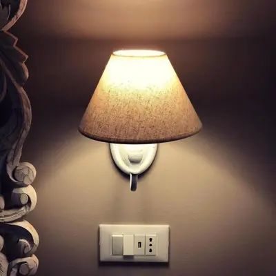 a light on the wall with a lamp on it at B&B Angolo83 Palermo centro in Palermo