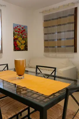 a table with a bowl on it in a living room at Boa Vista San Vito - Area Fitness, Barbecue Area, Tennis Court in San Vito lo Capo