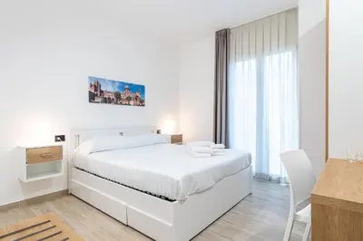 a bedroom with a bed and a large window at Solemar Sicilia - Multi Suite in Palermo