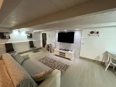 a living room with a couch and a flat screen tv at Casa vacanza toledo in Partinico