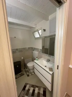 a bathroom with a white toilet and a sink at Casa vacanza toledo in Partinico