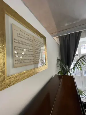 a picture hanging on a wall next to a window at Casta Diva Luxury Apartments -Self check-in in Palermo