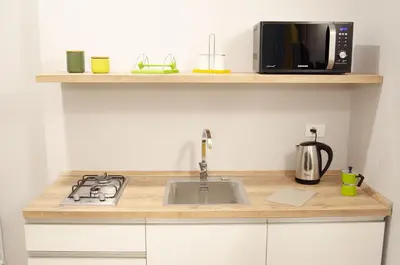 a kitchen counter with a sink and a microwave at Solemare Casa Vacanze in Castellammare del Golfo