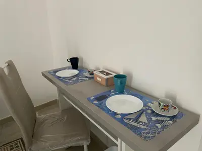 a kitchen with a sink and a tv on a wall at La casetta di Mavi in Palermo