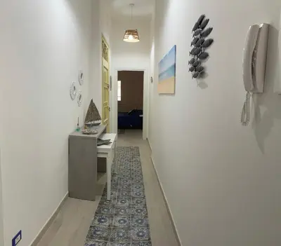a bedroom with a blue bed with two white towels on it at La casetta di Mavi in Palermo