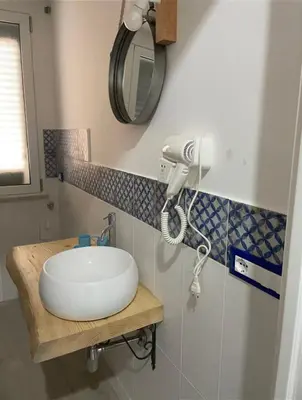 a bathroom with a sink and a shower at La casetta di Mavi in Palermo