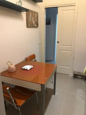 a dining room table with a chair and a door at Josh's House Mondello in Mondello