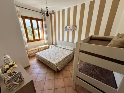 a small room with a bed and a bunk bed at Casa Vacanze Costanza in San Vito lo Capo